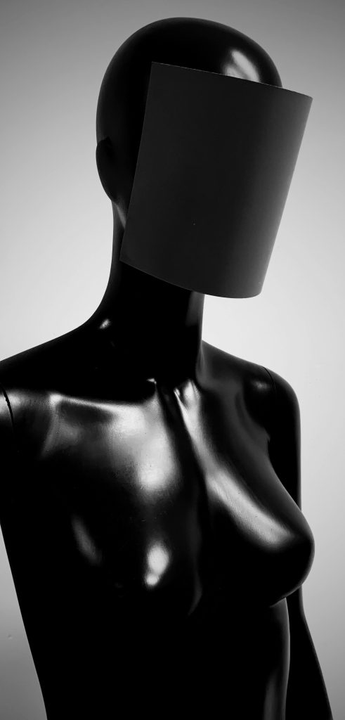 Faceless mannequin bust with a blank cone obscuring its head — dating app dehumanization essay, 49Grey